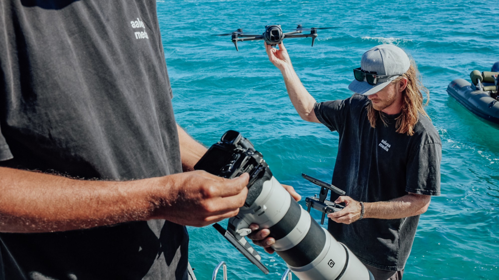 AALVAA crew launching a drone and shooting with a long lens from a boat